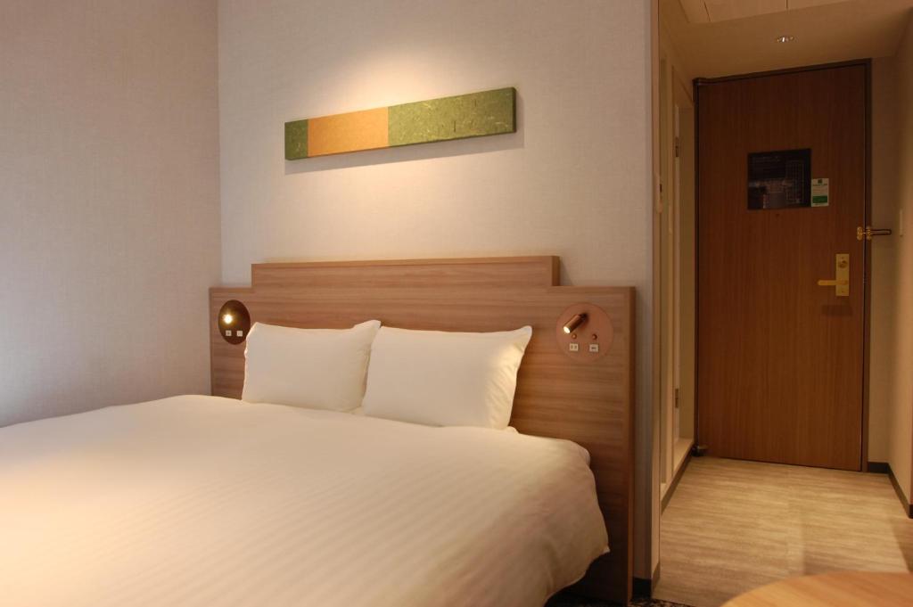 Postel nebo postele na pokoji v ubytování Izumo Royal Hotel