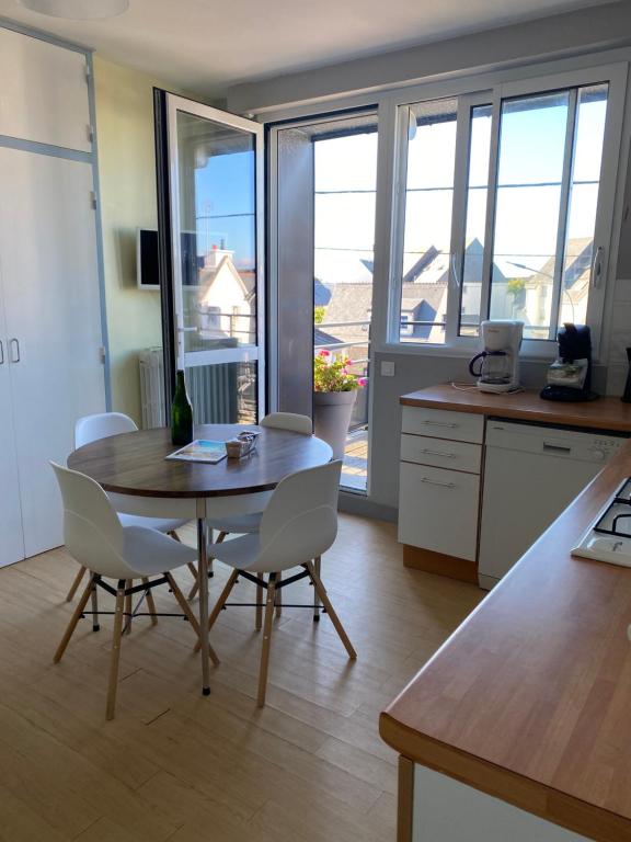 een keuken en eetkamer met een tafel en stoelen bij Ty Fanch Quiberon in Quiberon