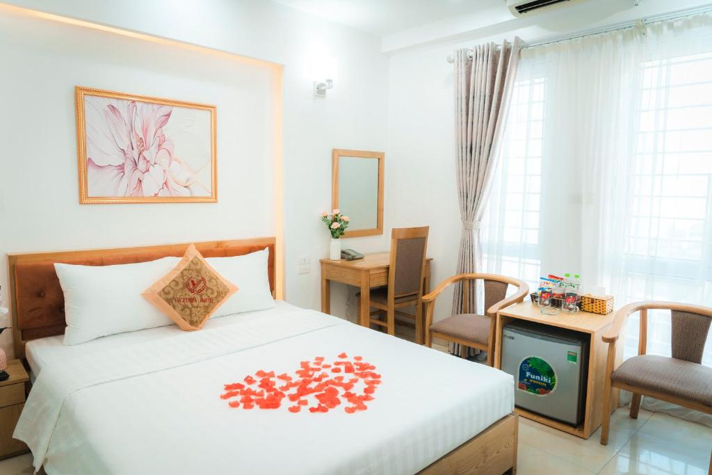 a bedroom with a bed and a tv at Victoria Hotel Me Tri in Hanoi