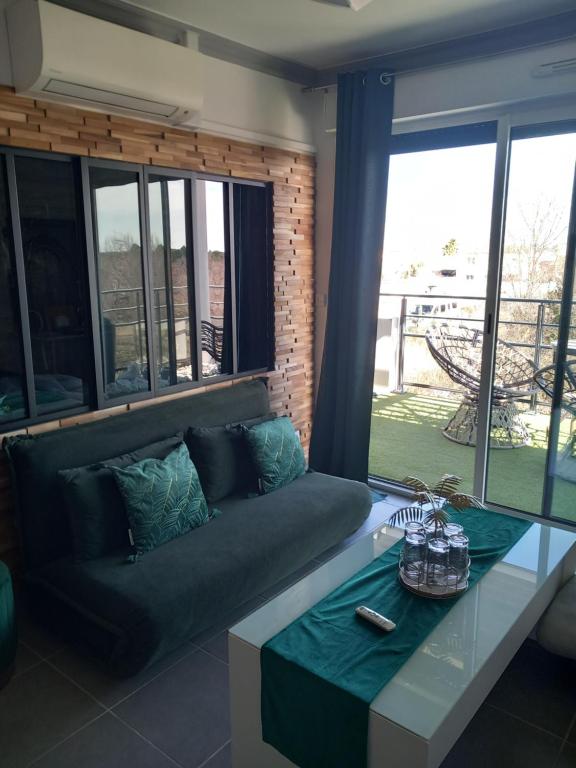 a living room with a couch and a table at Appartement de L'Espiguette in Le Grau-du-Roi