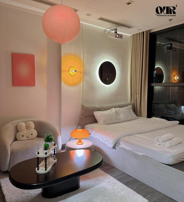 a bedroom with a bed and a table and a chair at TIL-Vinhomes Smart City Elegance Suites - Tay Mo in Phú Thú