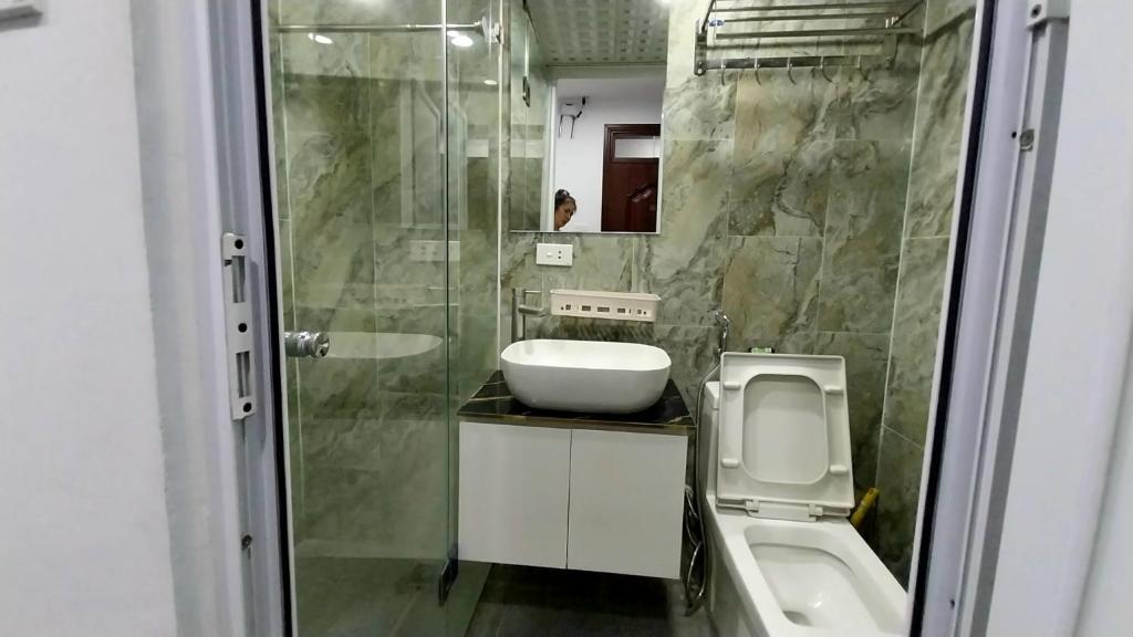 a bathroom with a sink and a shower and a toilet at 18 ngõ 154 Đình Thôn in Hanoi