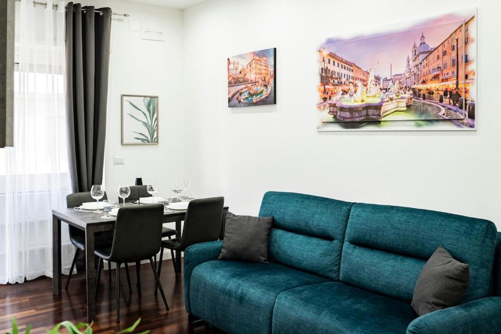 a living room with a blue couch and a table at Vaticano-Cornelia Luxury Home in Rome