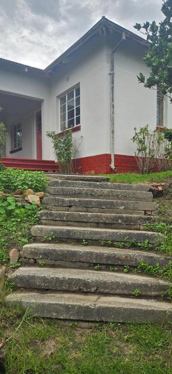 a set of stairs in front of a house at Old station house in Kareedouw