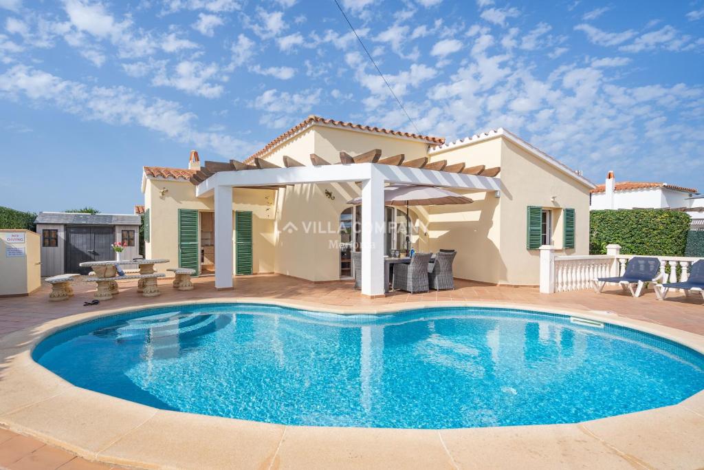 a swimming pool in front of a villa at Villa OCEANA in Cala en Porter