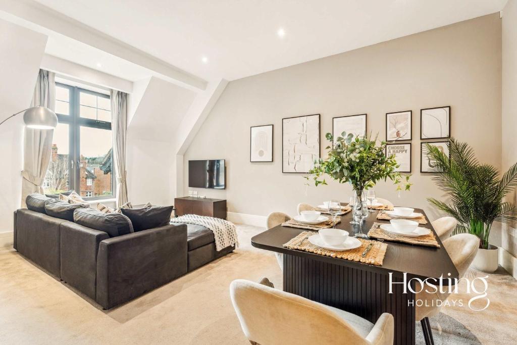 a living room with a couch and a table at The Sovereign Suite - 2-bedroom Luxury Apartment with Parking in Henley on Thames