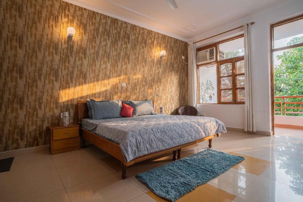 リシケーシュにあるLuxury Villa Rishikeshのベッドと壁のある寝室