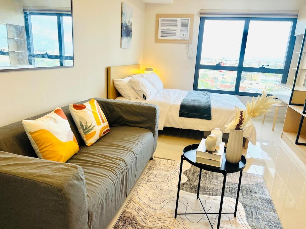 a living room with a couch and a bed at J Tower Residences in Mandaue City