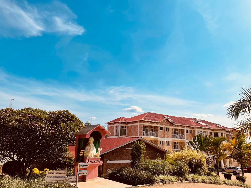 a building with a statue in front of it at CENTRE PASTORAL SAINT AUGUSTIN RWAMAGANA in Rwamagana