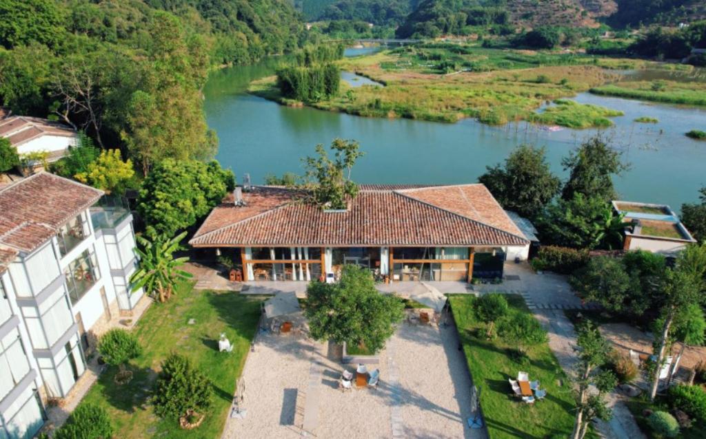 an aerial view of a house next to a river at Yingde YeDuGu Resort in Gaozhoupu