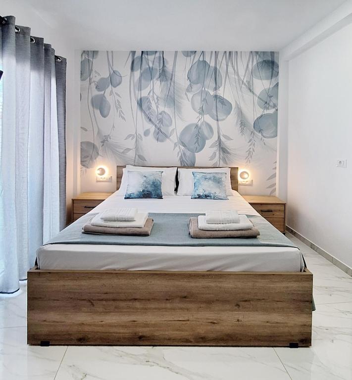 a bedroom with a large bed with two towels on it at Coastal Ierapetra 2 in Ierapetra