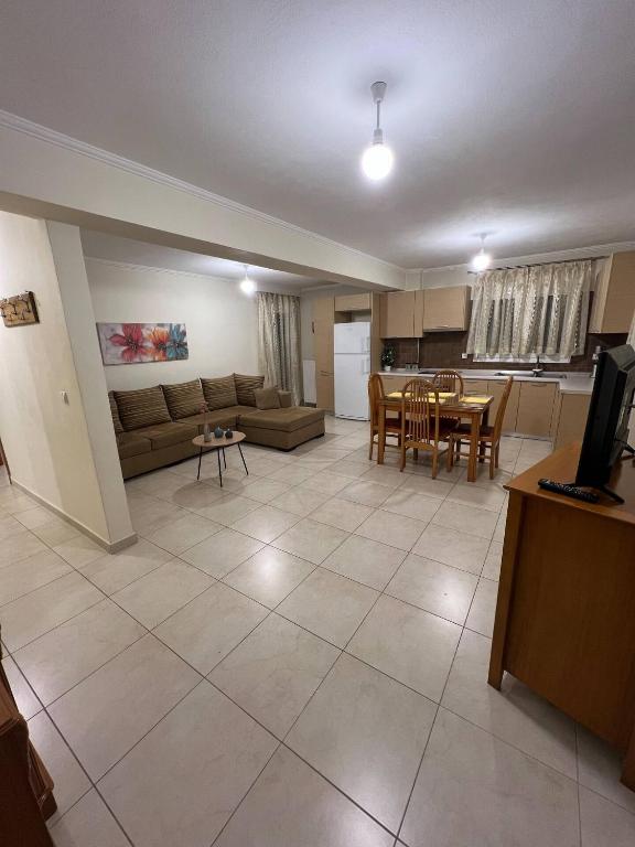 a living room with a couch and a table at TranquilityHouse in Tríkala