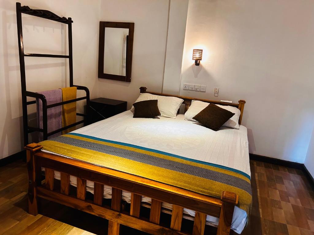 Postel nebo postele na pokoji v ubytování Pearl Bungalow Trincomalee
