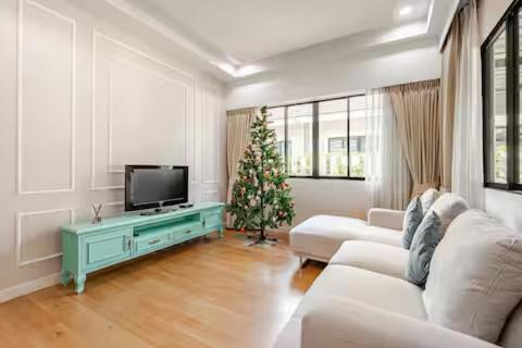 a living room with a christmas tree and a television at Villa Siri 49 Luxury 4 BR Chiang Mai in Chiang Mai