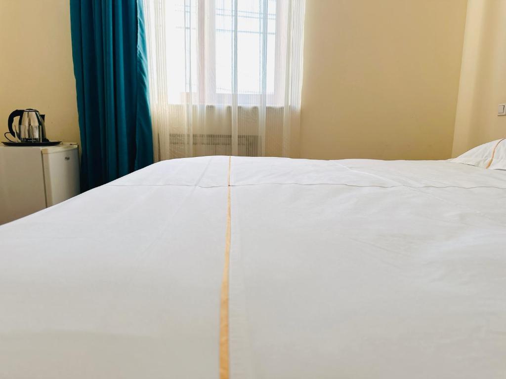 Postel nebo postele na pokoji v ubytování SD Hotel