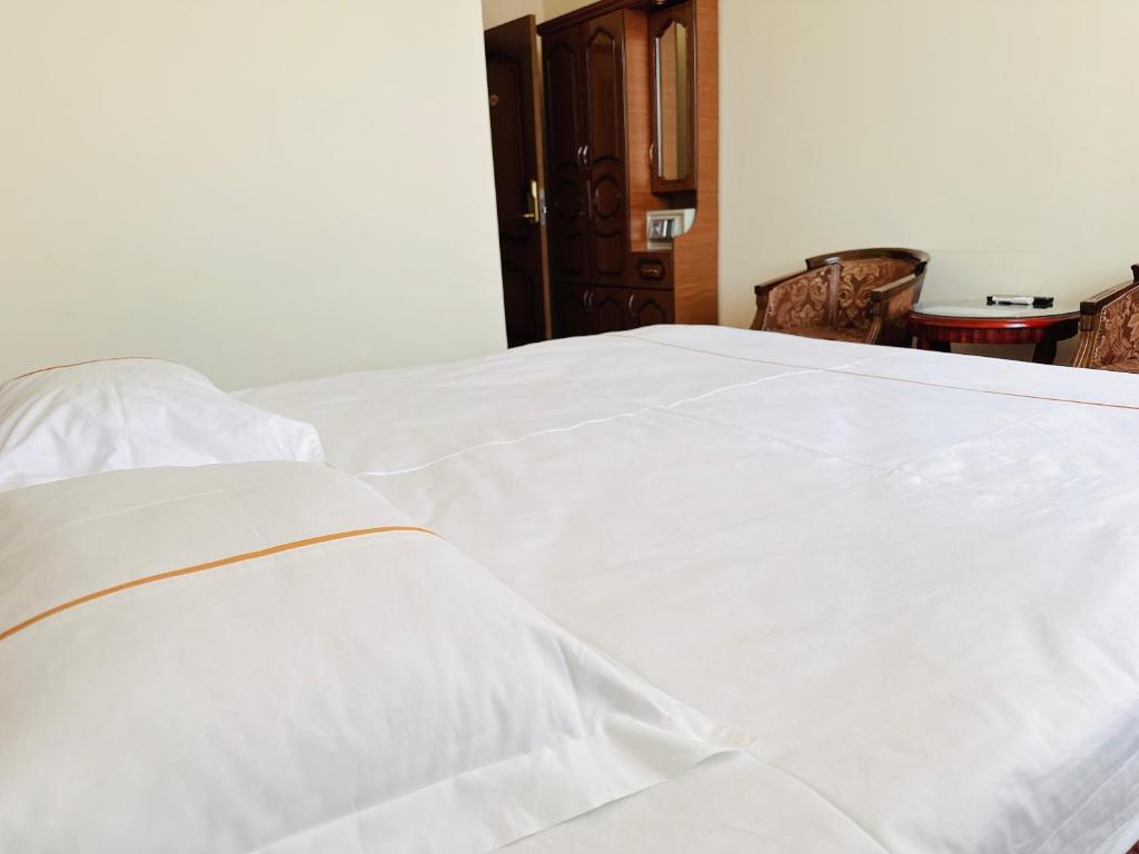 Postel nebo postele na pokoji v ubytování SD Hotel