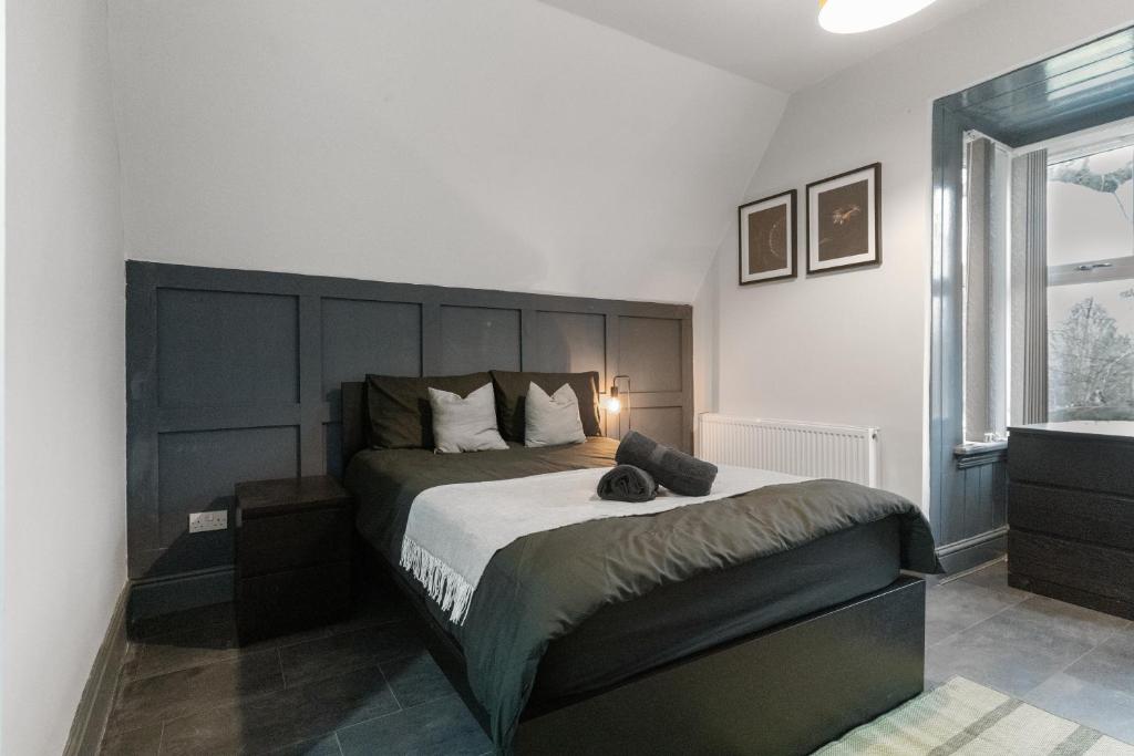a bedroom with a large bed and a window at Luxury Moseley Studio - 8 in Birmingham