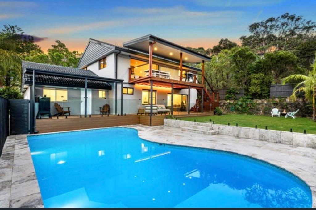 a house with a swimming pool in front of it at Ausykillar in Forestville