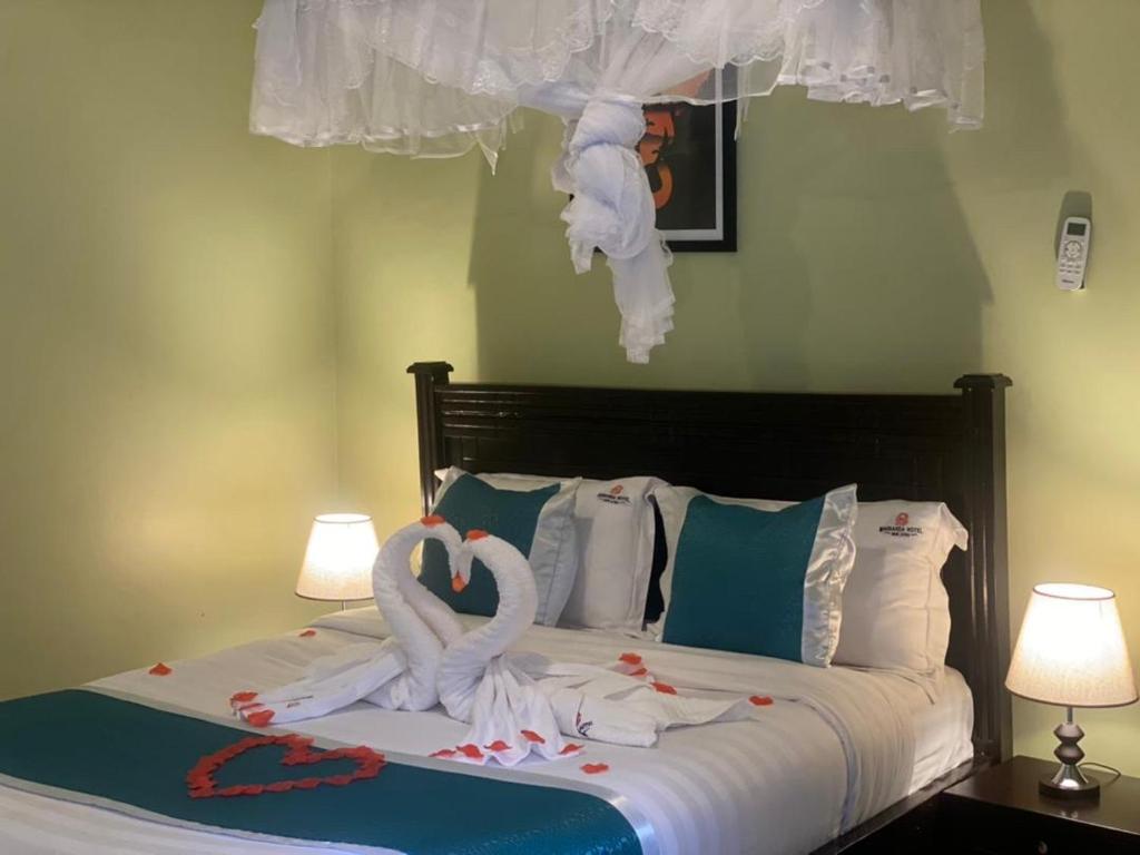 Postel nebo postele na pokoji v ubytování BWIRANDA HOTEL