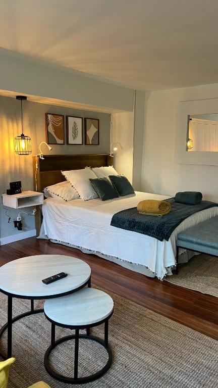 a bedroom with a large bed and two tables at Apartamento independiente Suite - Recién reformado y parking gratis in Castro-Urdiales