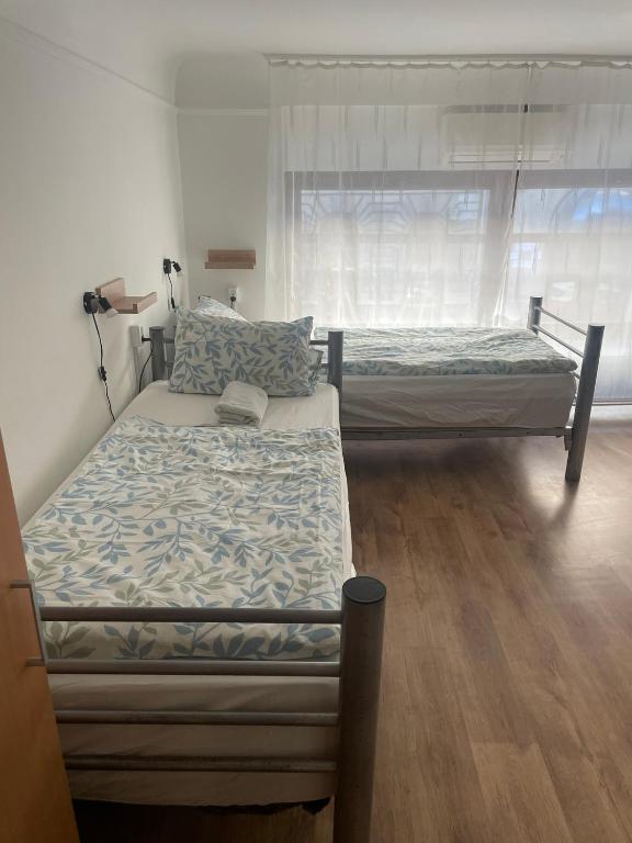 A bed or beds in a room at Center Hostel and Guest House