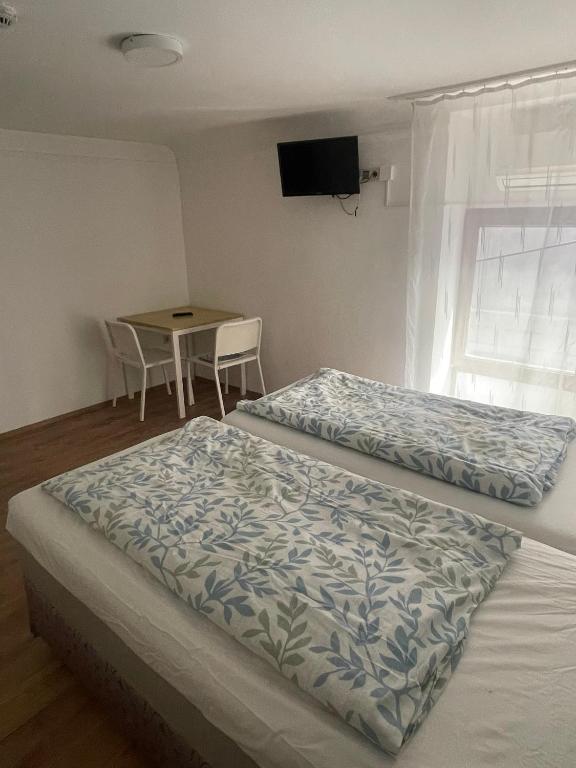 A bed or beds in a room at Center Hostel and Guest House
