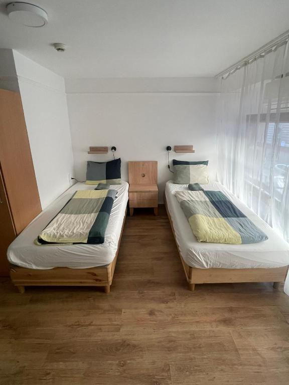 A bed or beds in a room at Center Hostel and Guest House