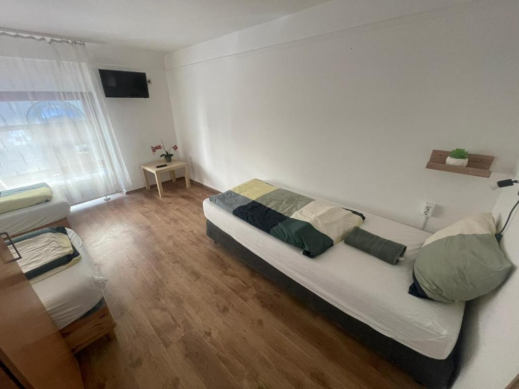 A bed or beds in a room at Center Hostel and Guest House