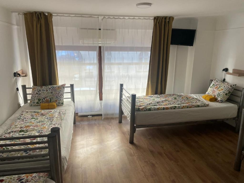 A bed or beds in a room at Center Hostel and Guest House