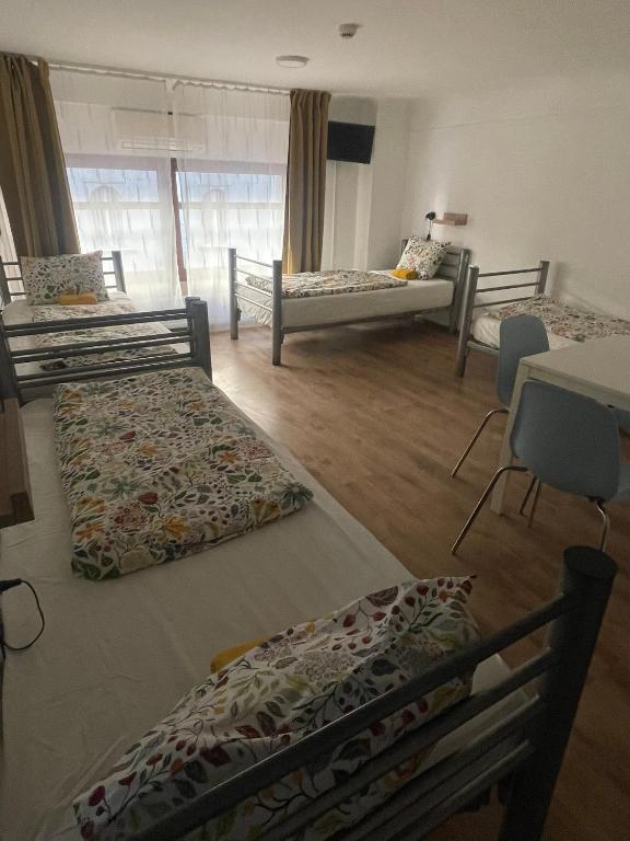 A bed or beds in a room at Center Hostel and Guest House