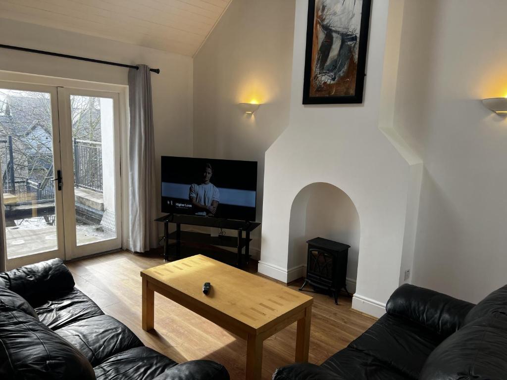 a living room with a couch and a tv at Lough Derg Holidays in Mountshannon