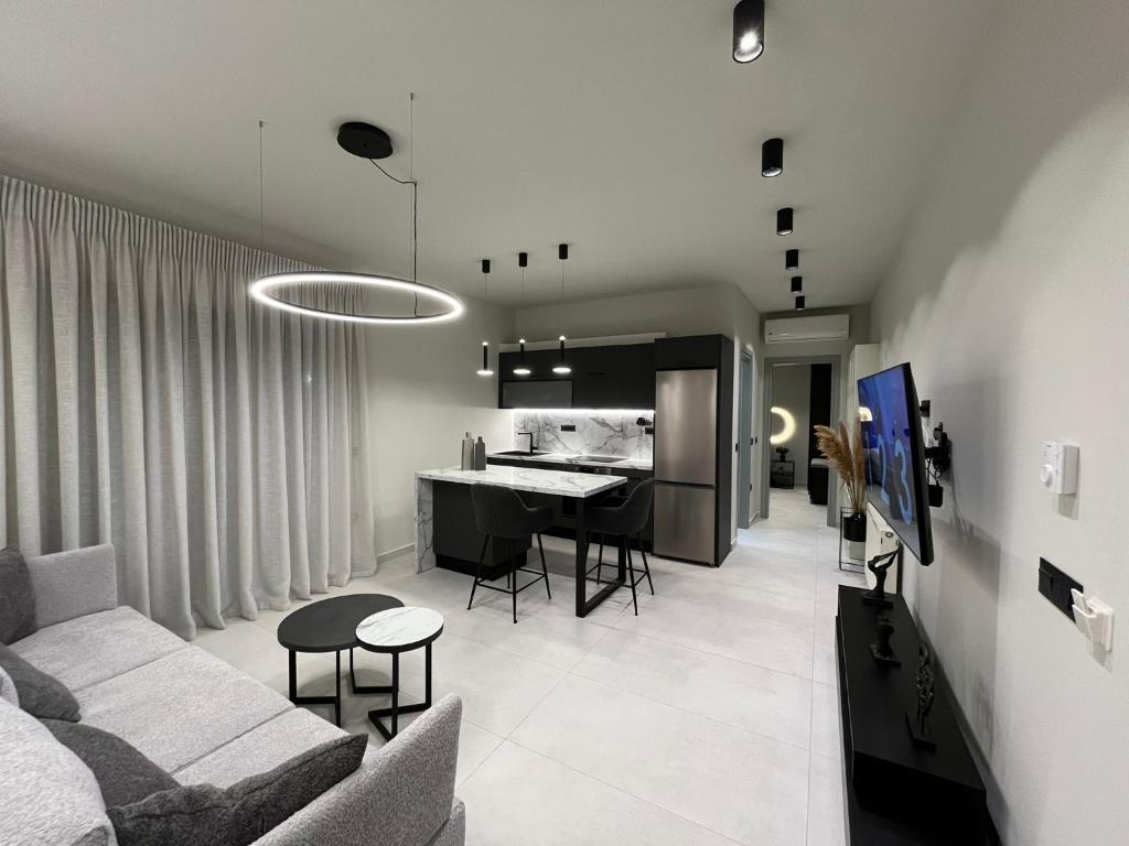 a living room and kitchen with a couch and a table at Casa Joelia in Skala