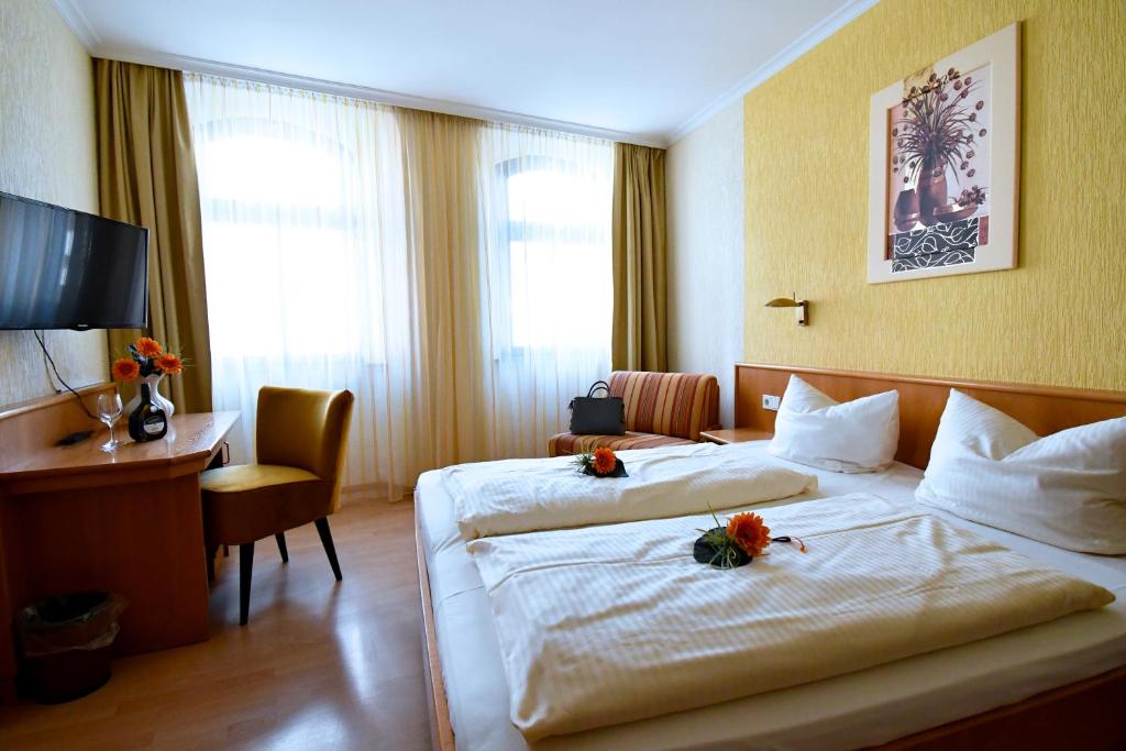Postel nebo postele na pokoji v ubytování AKZENT Hotel Grüner Baum