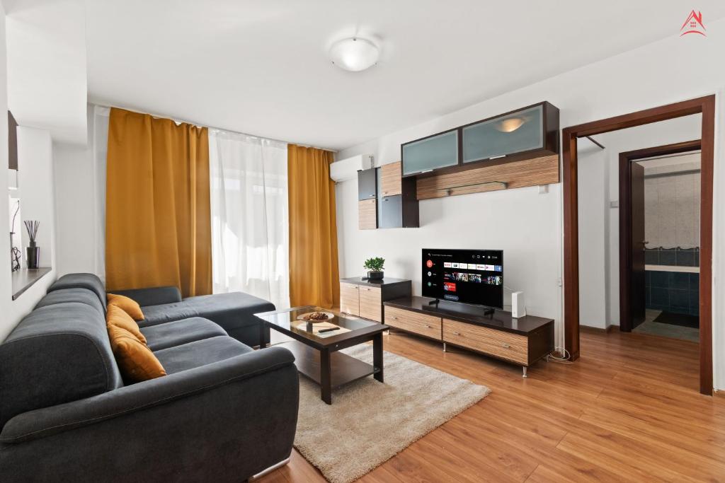 a living room with a couch and a tv at Charm Apartment - Old Town in Bucharest