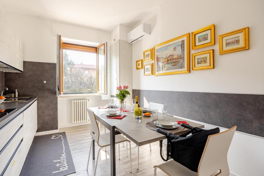 a kitchen and dining room with a table and chairs at Garda Art&Lake in Peschiera del Garda