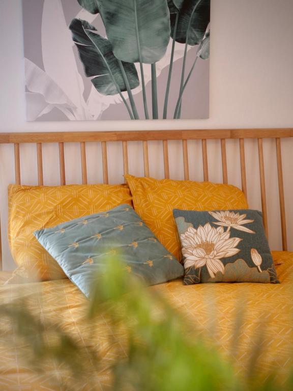 a bed with two pillows on top of it at Chill Out, bungalow ensoleillé in Grand-Bourg