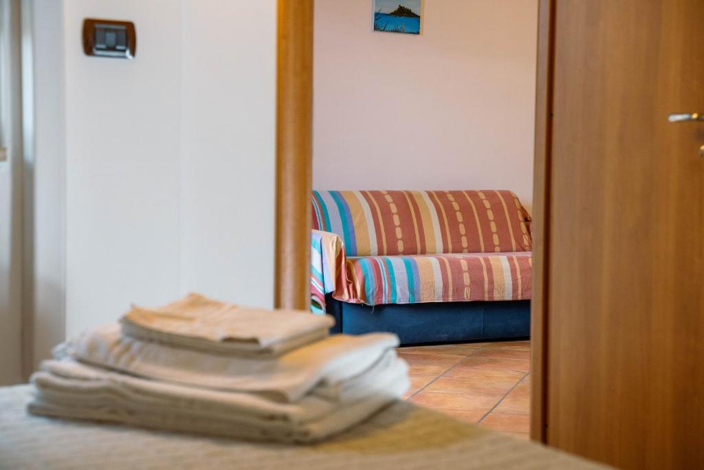 a stack of towels on a table in a living room at Le Tartarughe Aparthotel in Letojanni
