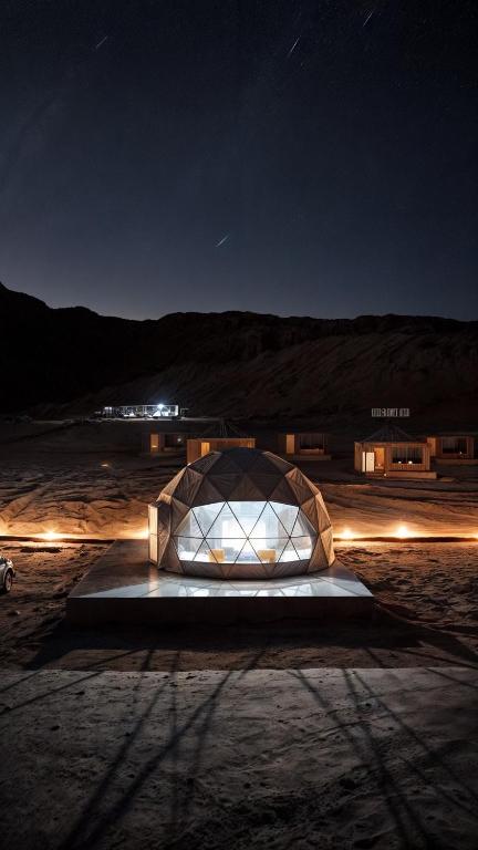 a building with a glass dome at night at Wadi Rum party luxury camp in Disah