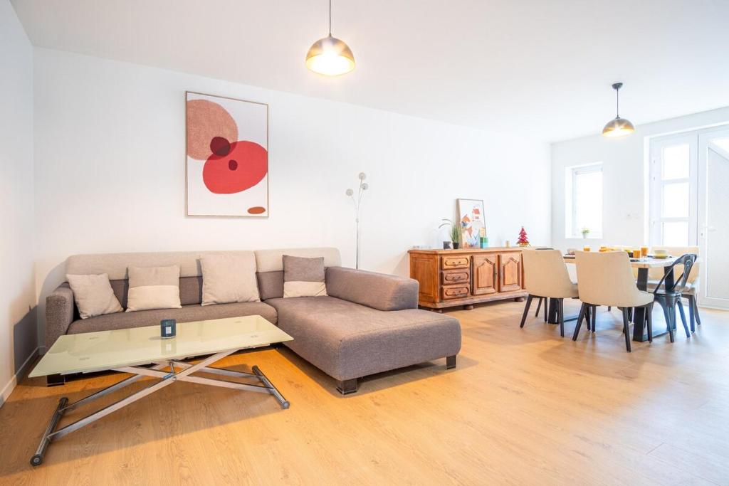 a living room with a couch and a table at Gite le palefrenier - 6 pers - 10 min Etretat in Gonneville-la-Mallet