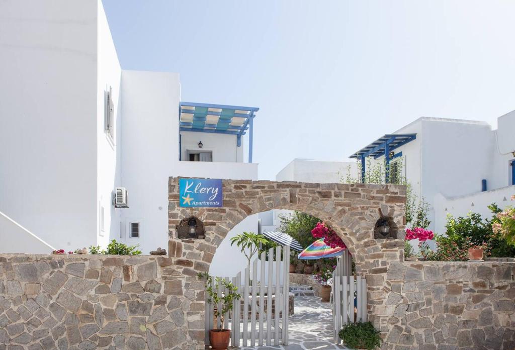 a stone archway with a gate in front of a building at Apartments Klery - Studios 3 in Naousa