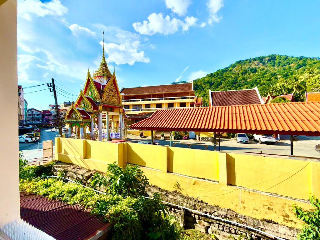 a city with a yellow fence and a building at Patong Canal Villa 211 in Patong Beach