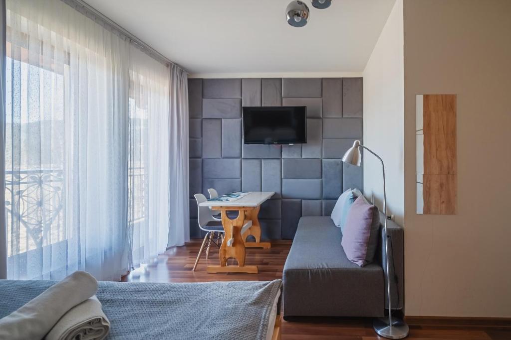 Televízia a/alebo spoločenská miestnosť v ubytovaní Tatry Panorama