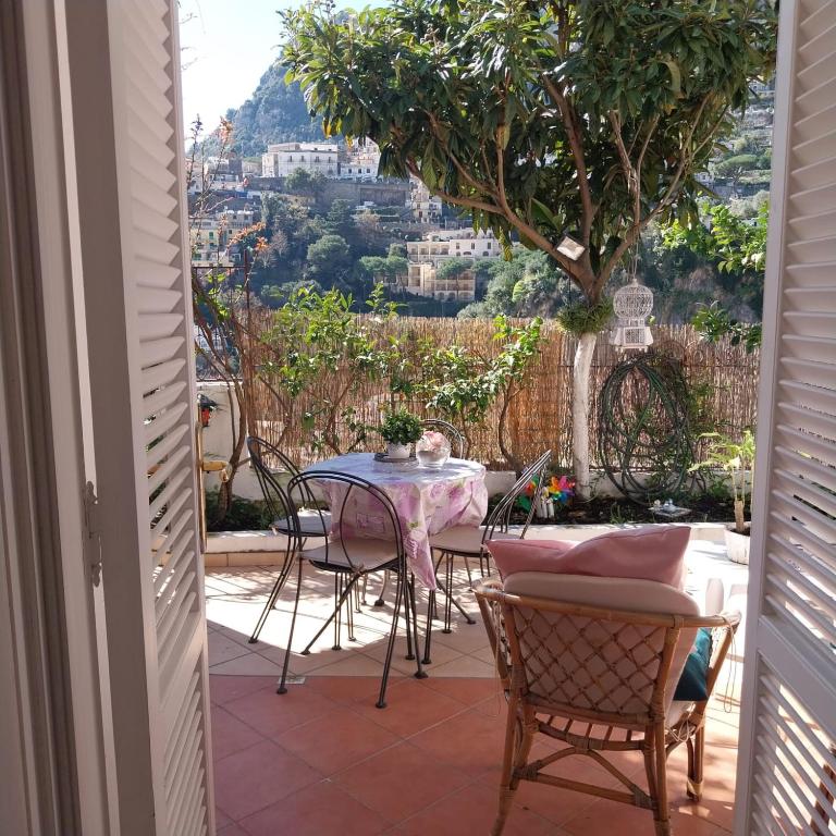a table and chairs on a patio with a view at Positano Casa Delizia in Positano