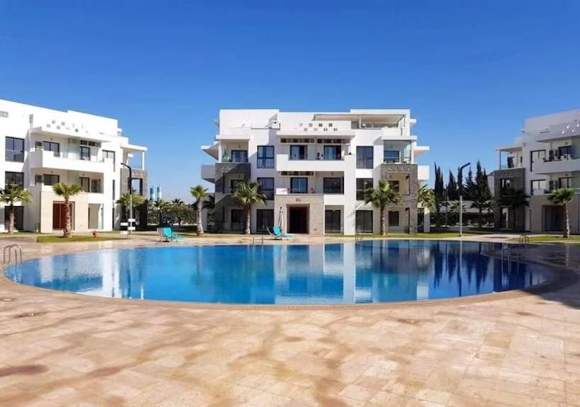 a large swimming pool in front of a building at Hivernage Residence, Modern 2 Bedroom in Agadir