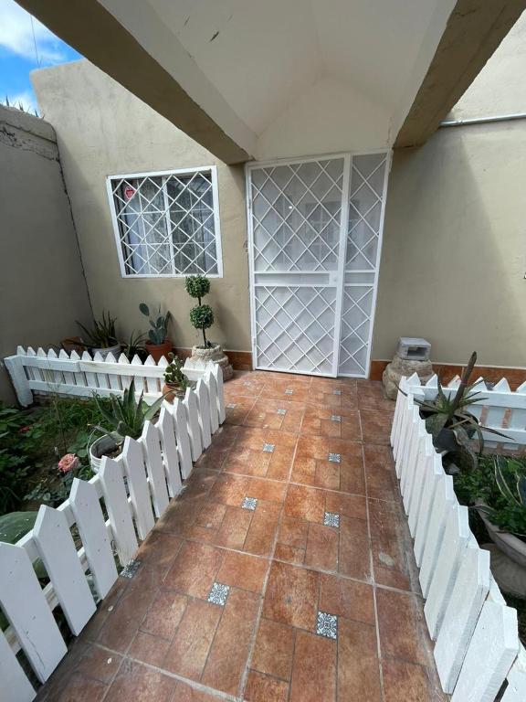a house with a white fence and a patio at GR20acd Corredor Comercial in Cuauhtémoc