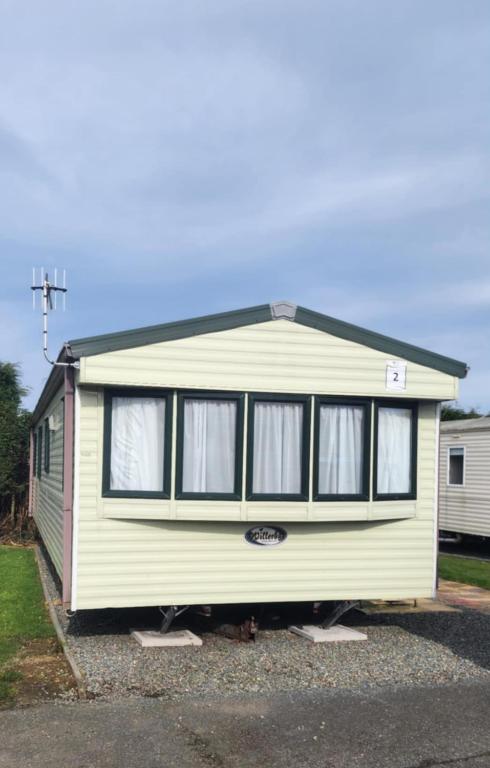 a yellow caravan is parked in a parking lot at 2 Vale Park in Fishguard