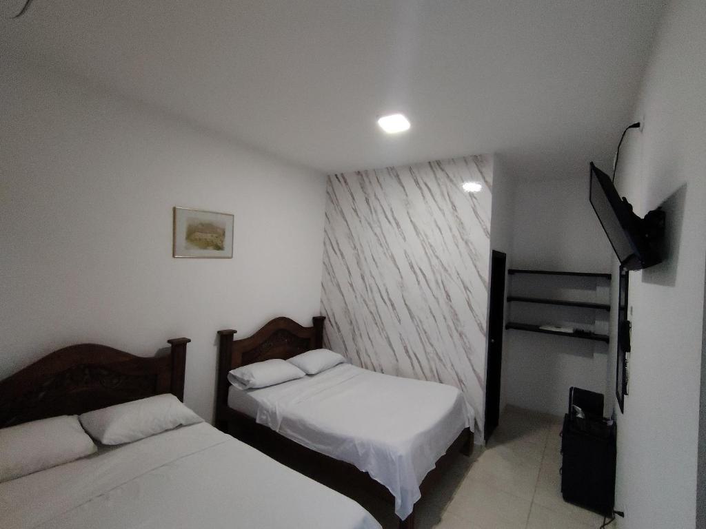 Postel nebo postele na pokoji v ubytování Hotel Palmari
