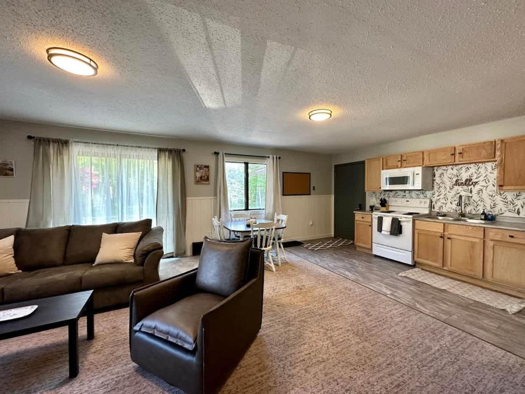 a large living room with a couch and a kitchen at Winter Wonderland Chalet at Powderhorn Mountain in Bessemer