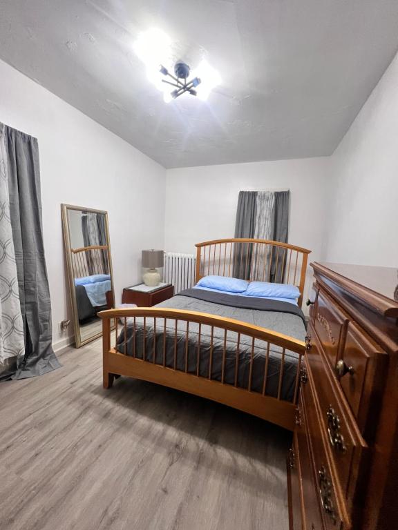 a bedroom with a bed and a ceiling fan at Preston Serenity Room With Shared Bath & Kitchen in Hartford