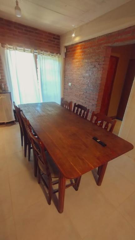 a large wooden table with chairs in a room at Hospedajes JUJUY in Palpalá
